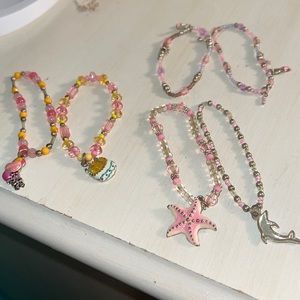 Three sets of two bracelets so new and cute with charms never used